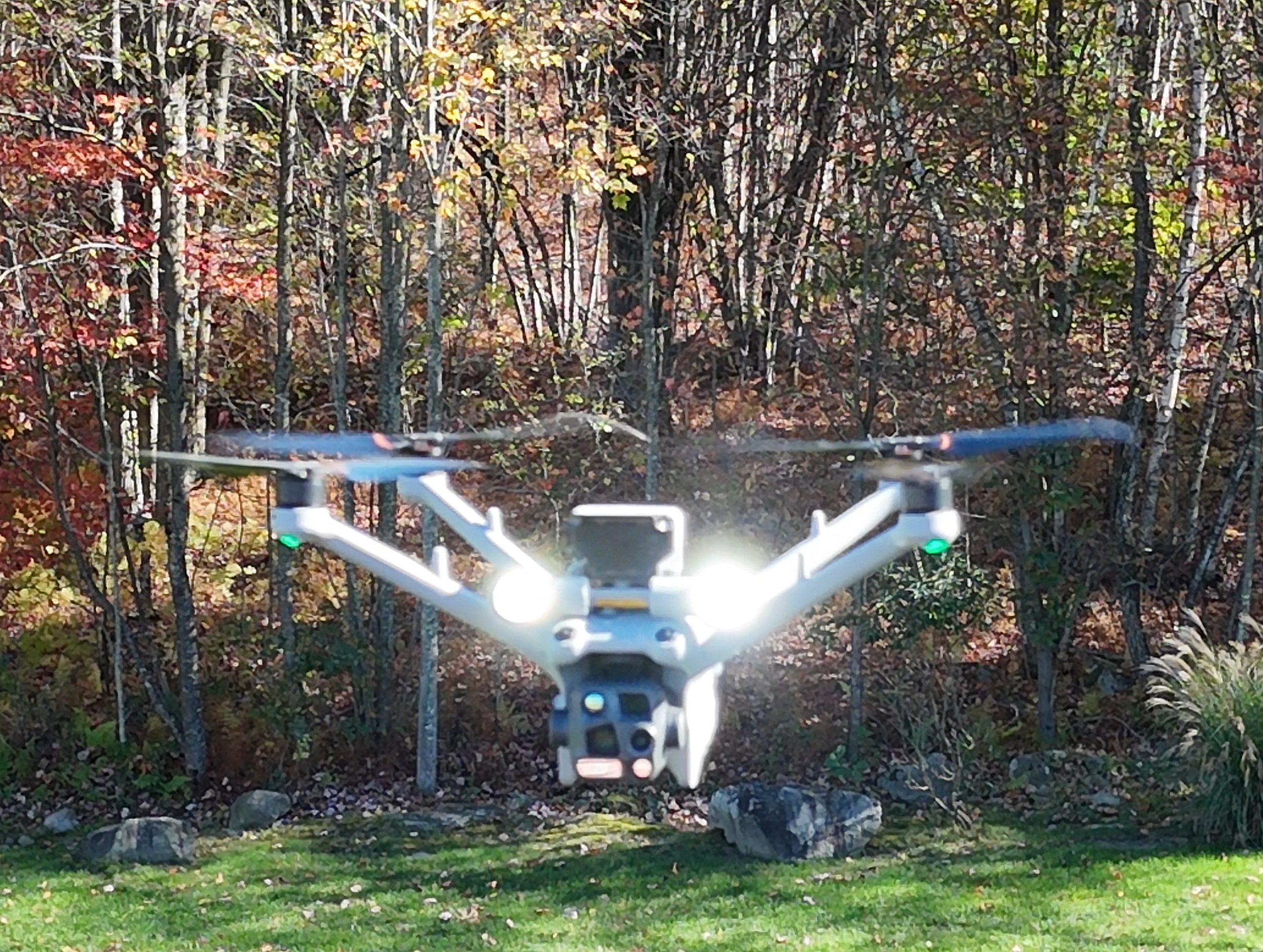 DJI Matrice 4TD drone hovering at night with its lights on